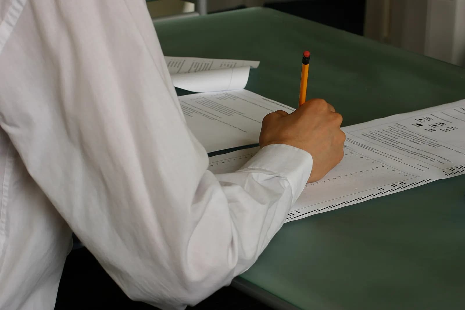 Hand writing an exam in a classroom